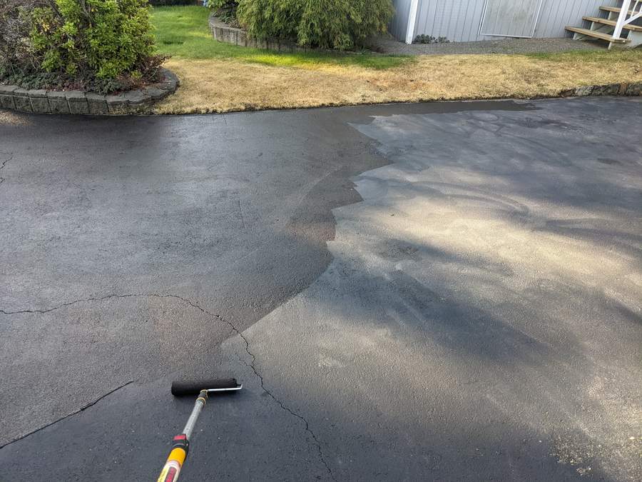 Power washing a stained driveway on a Sidney property